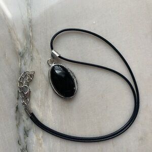 1906 Sleek Black and Silver Oval Pendant Necklace
